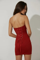 Back view of elegant red strapless mini dress with lace-up corset detail for women